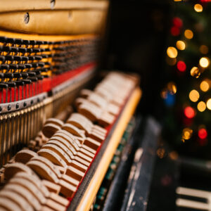 Piano keyboard with Christmas decoration, closeup